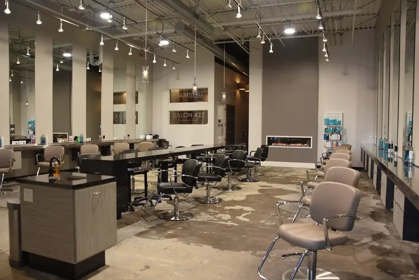 Modern salon interior with styling chairs, mirrors, and open layout.